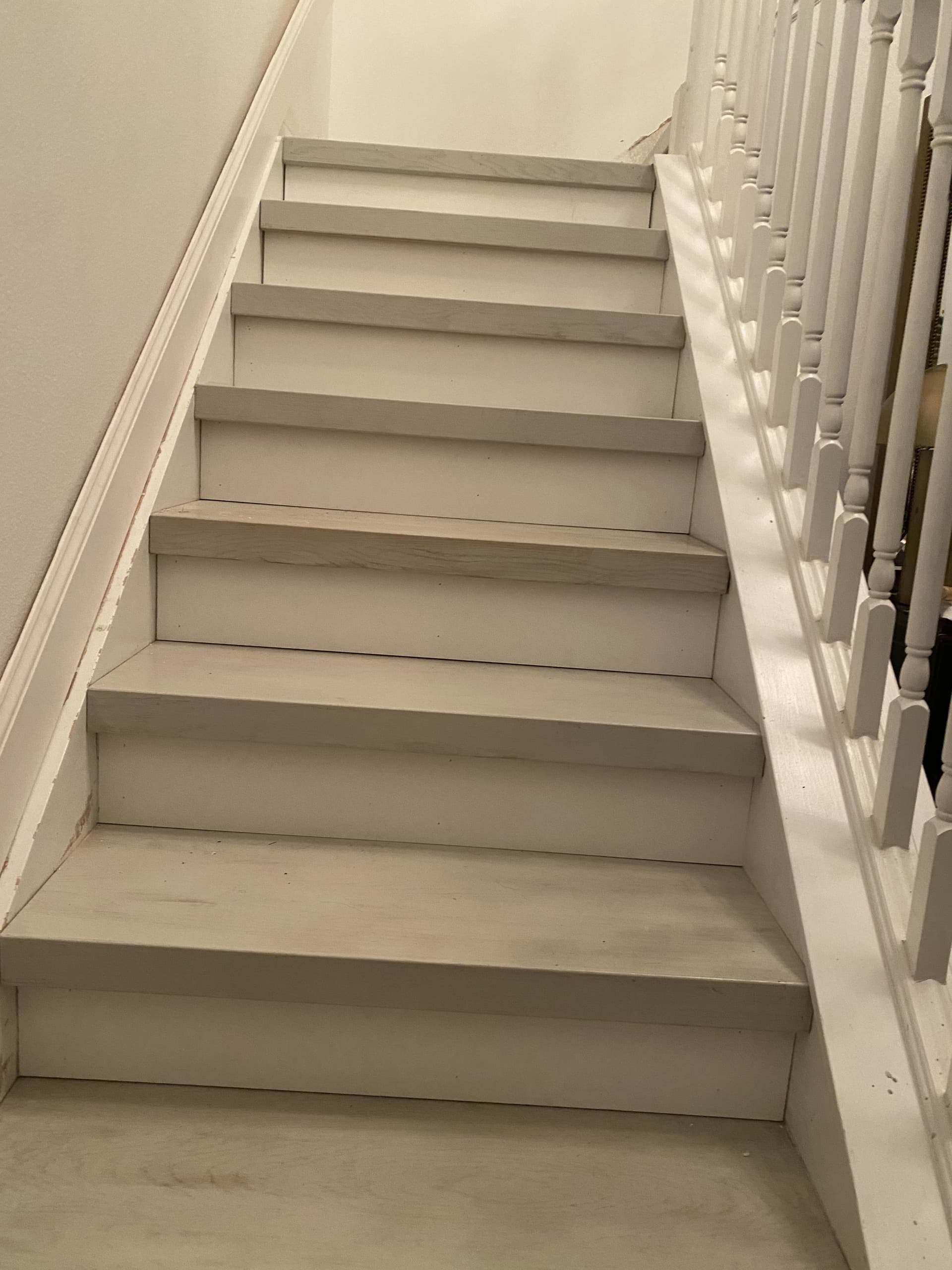 Freshly painted white staircase with white treads, risers and turned balusters and newel post — Karhan Construction, Orlando