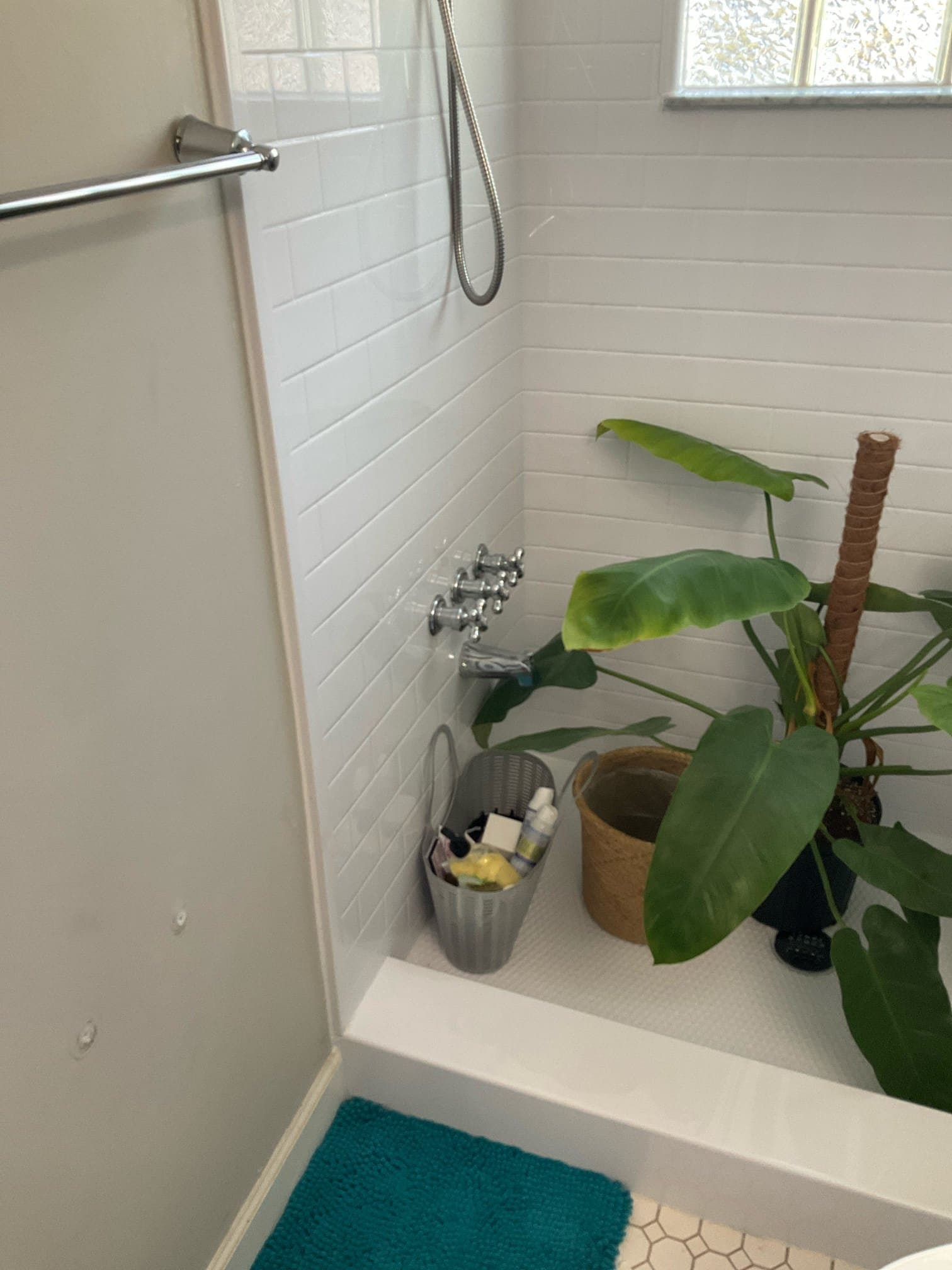 BEFORE — original shower, glass-block window and worn fixtures (real Karhan project)