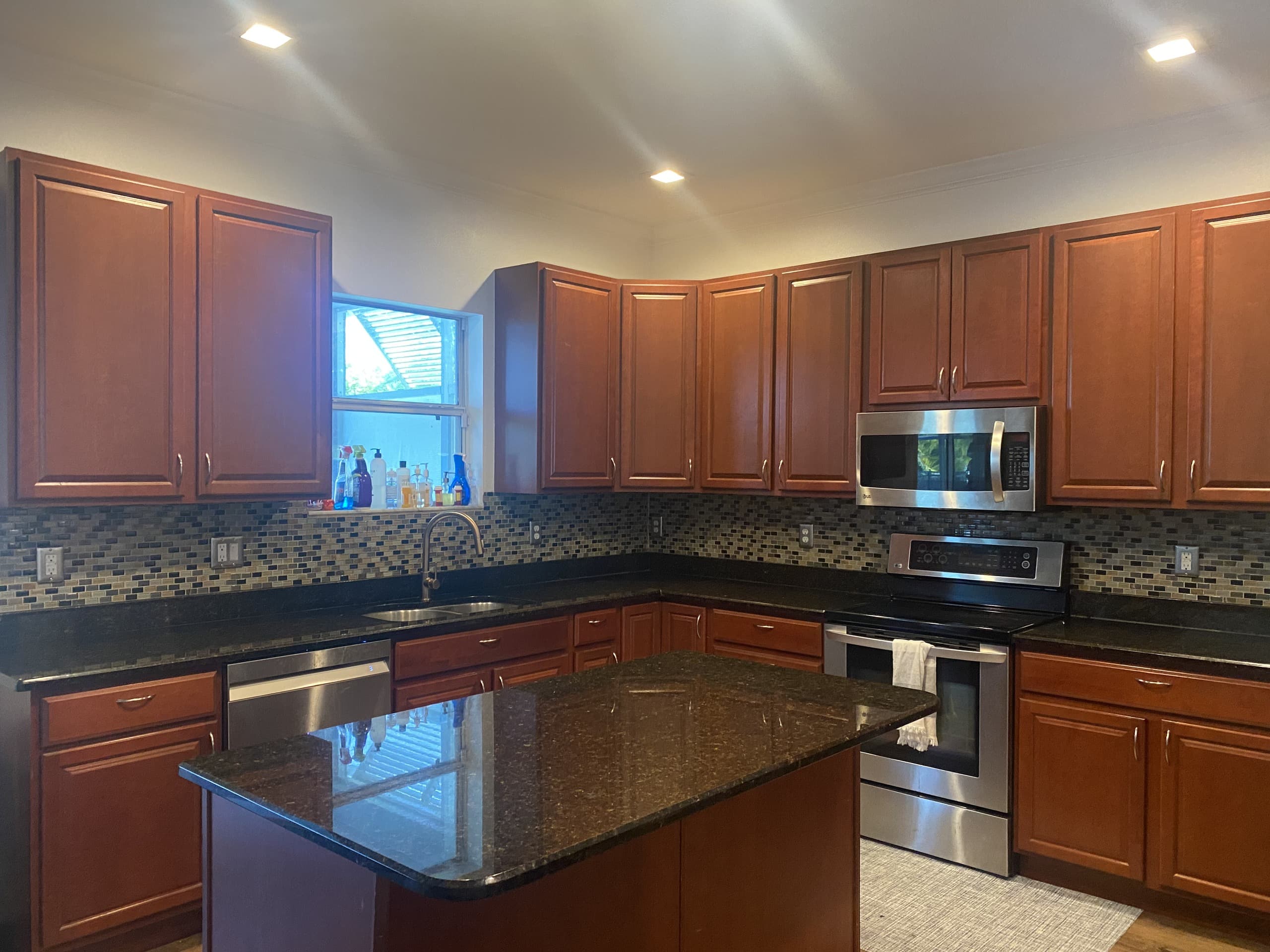 BEFORE — cherry cabinets and older appliances by the window (real Karhan project)