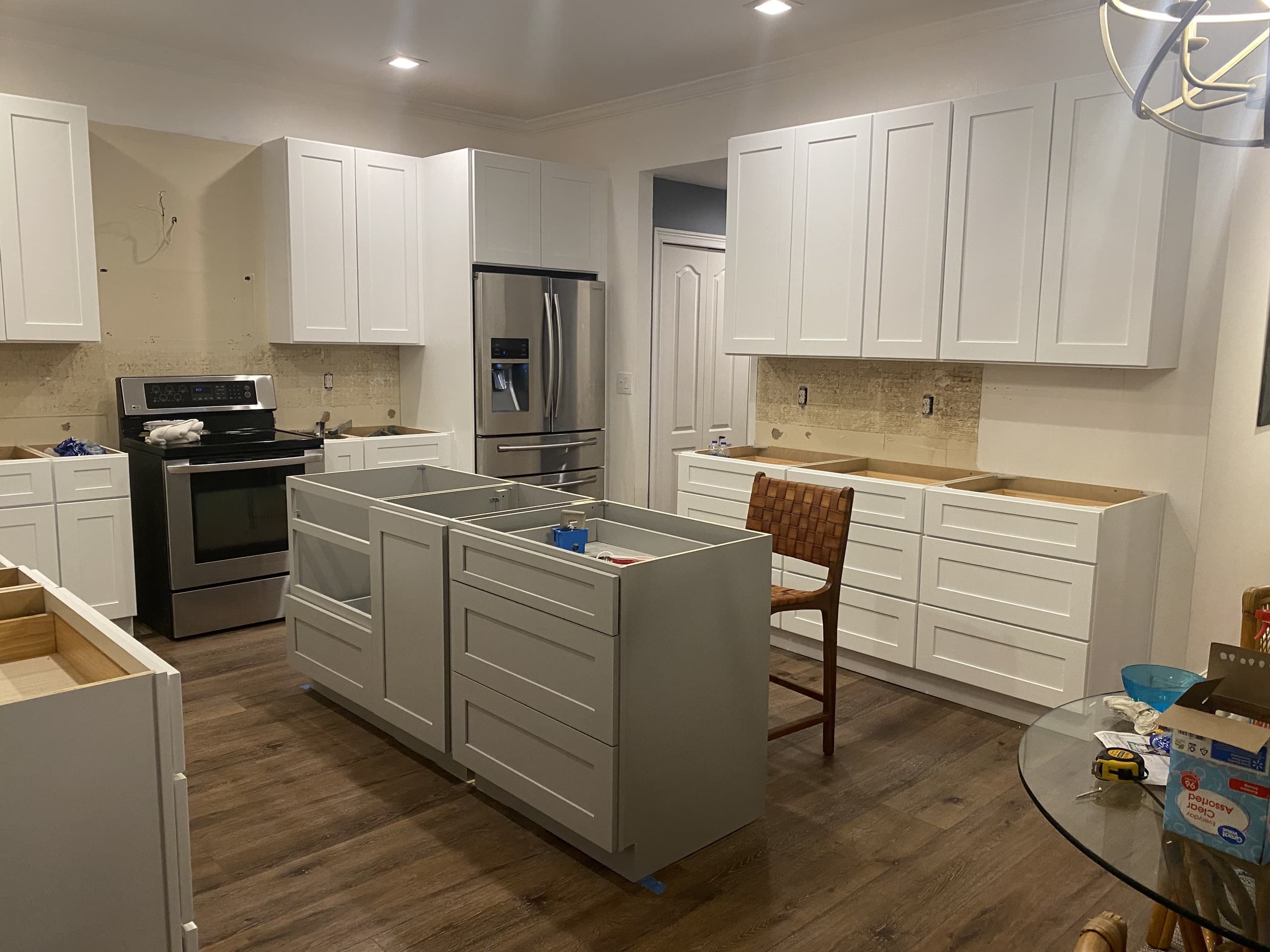 DURING — cabinet runs set and island framed, awaiting quartz (real Karhan project)